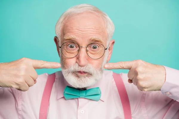 Closeup photo of crazy funky grandpa press fingers on cheeks big eyes mouth full air not breathing wear specs pink shirt suspenders bow tie isolated bright teal color background — Stok fotoğraf