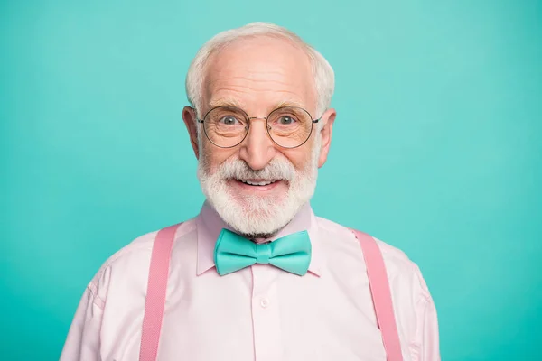 Closeup photo of amazing stylish clothes grandpa positive facial expression smile good mood wear specs pink shirt suspenders bow tie isolated bright teal color background — 스톡 사진