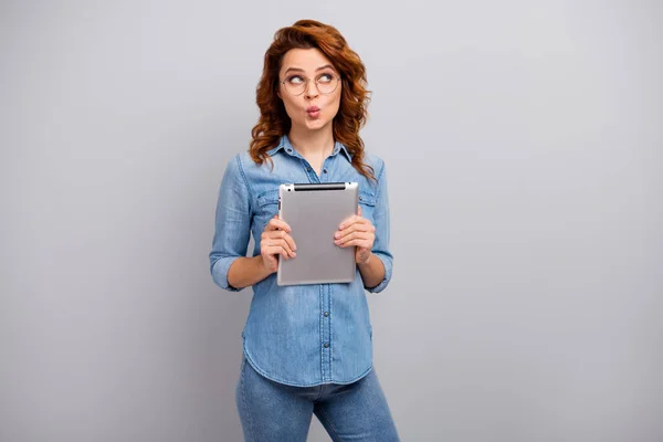 Portrait of lovely cute pretty interested woman hold use tablet social media website look copyspace think thoughts send air kiss wear style stylish outfit isolated over grey color background — Stockfoto