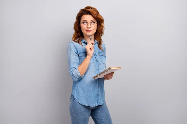 Portrait of interested minded woman teacher write lecture look copyspace think thoughts decide solution wear denim jeans shirt isolated over grey color background — Stock fotografie
