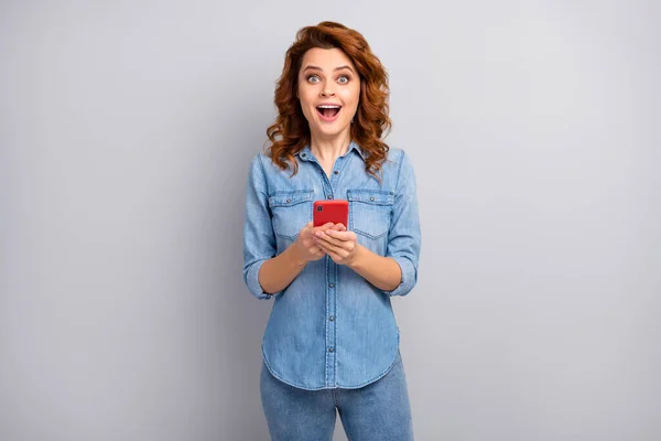 Portrait of astonished crazy woman use cell phone read social media novelty impressed scream wow omg wear good look outfit isolated over grey color background — ストック写真