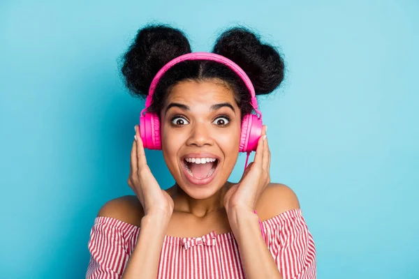 Closeup photo of funny nice dark skin lady listen music modern technology earphones open mouth favorite song wear trendy red white striped shirt off-shoulders isolated blue color background — 스톡 사진