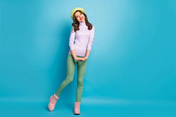 Πλήρης φωτογραφία του σώματος της πολύ ωραία κυρία κομψή εμφάνιση καλή διάθεση τα πόδια δρόμο στο εξωτερικό φορούν μοντέρνο πράσινο μπερέ καπέλο μωβ ζιβάγκο πουλόβερ παντελόνι παπούτσια απομονωμένο μπλε χρώμα φόντο — Φωτογραφία Αρχείου