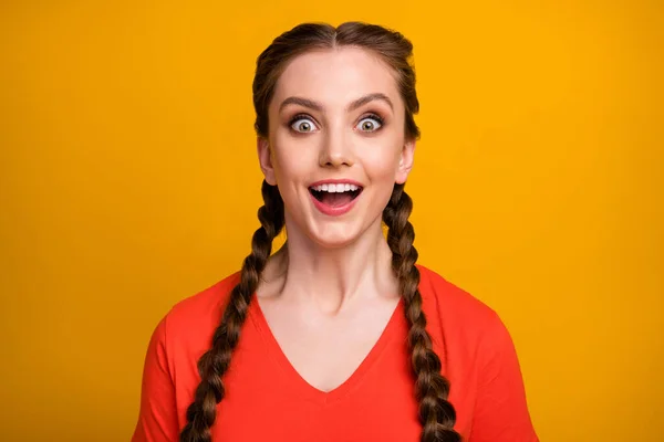 Closeup photo of funny attractive cheerful lady two cute long braids good mood listen unexpected amazing news open mouth wear casual red t-shirt isolated vibrant yellow color background — Stock Photo, Image