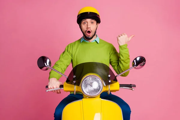 Portrait of his he nice atrakted amazful cheery guy riding moped shows cool incredible advert ad decision isolated over pink pastel color background — Stok Foto