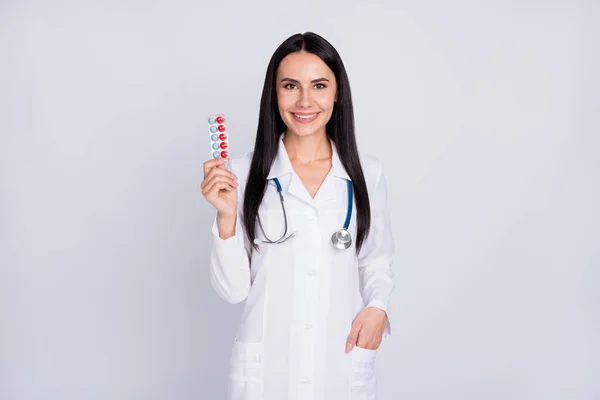 Fénykép a gyönyörű professzionális orvos hölgy javasolja a legjobb tabletták C-vitamin profilaktikus téli tabletta viselni sztetoszkóp fehér köpeny elszigetelt szürke színű háttér — Stock Fotó