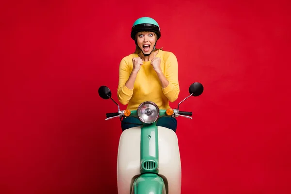 stock image Portrait of her she nice attractive lovely amazed cheerful cheery crazy overjoyed girl sitting on moped great news isolated on bright vivid shine vibrant red color background