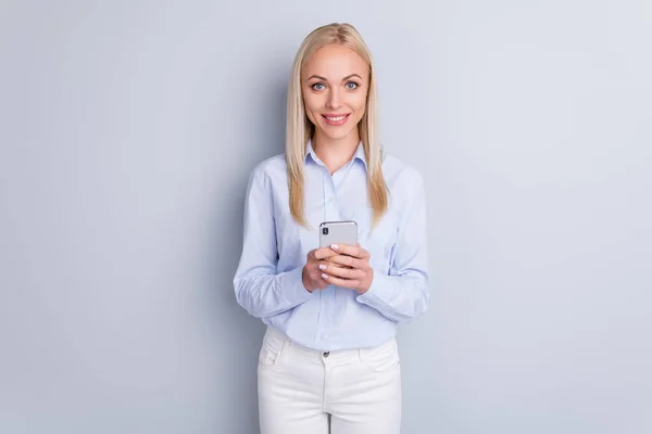 Портрет очаровательный контент девушка использовать мобильный телефон пользуются социальной сети носить хороший внешний вид наряд изолирован на сером фоне цвета — стоковое фото