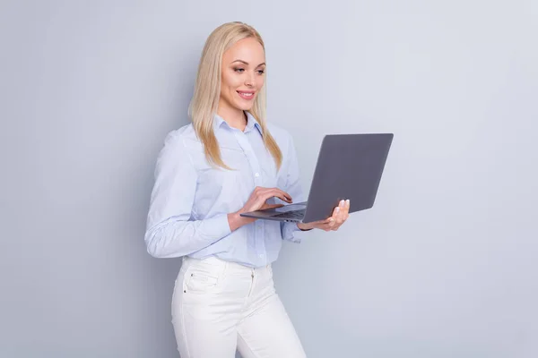 Photo of positive cheerful confident smart girl use laptop read company development information have online communication wear good look trousers isolated over gray color background — Stock Photo, Image