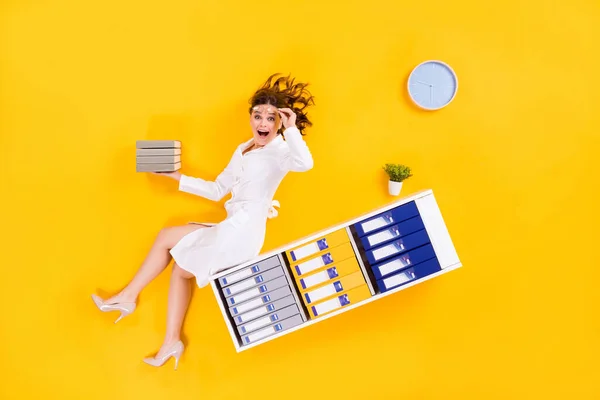Top above high angle view full size photo shocked woman surgeon sit shelf hold pile stack book find coronavirus epidemic stop danger cure flat lay impressed isolated bright color background — Stock Photo, Image