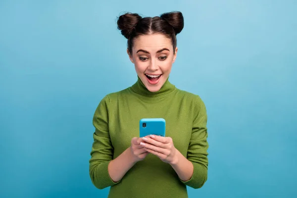 Photo of attractive pretty teen lady open mouth chatting browsing telephone read blog post addicted smart phone user wear warm green turtleneck isolated blue color background