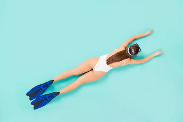 Top above high angle view full size back rear spine photo happy girl swim underwater coral reef have scuba equipment wear white body suit lay isolated turquoise color background — Stock Photo, Image