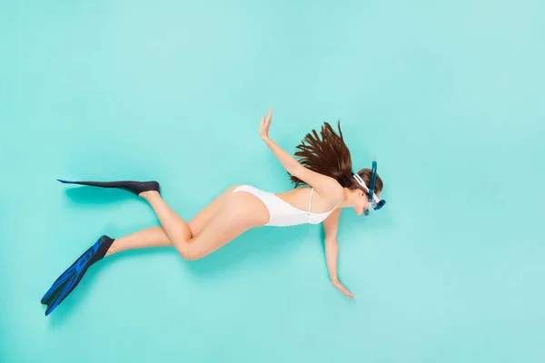 Top above high angle view full size profile side photo of happy girl swim scuba equipment underwater wear white body suit lay isolated over turquoise color background — Stock Photo, Image