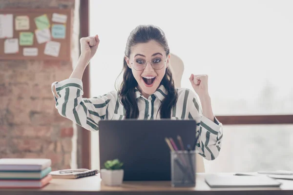 Close-up portrait of nice attractive cheerful cheery glad girl looking at screen display celebrating having fun at modern brick loft industrial interior style work place station — Stock Photo, Image