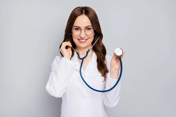 Portrait of her she nice attractive cheerful confident wavy-haired doc examining client patient diagnostic center clinic listening heart beat isolated over grey pastel color background — Stock Photo, Image