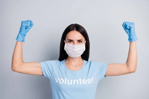 Close-up portrait of her she nice attractive lovely strong powerful girl medic doc voluntary work worker job demonstrating muscles save planet globe isolated over grey pastel color background