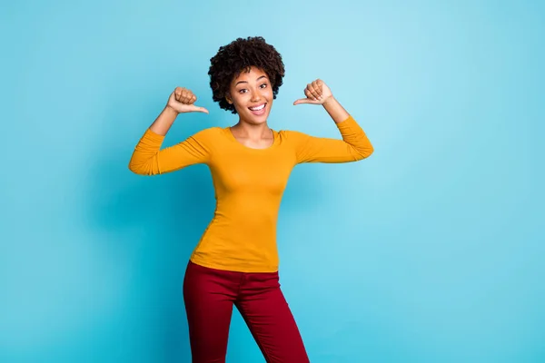 I am best. Cheerful candid afro american girl point herself with index finger enjoy her personality wear stylish trendy red pants trousers isolated over blue color background — Stock Photo, Image