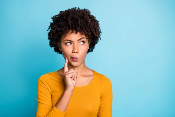 Concentrated afro american girl look copyspace think thoughts decide decisions choose choice hesitate solution touch chin fingers wear casual style jumper isolated blue color background — Stock Photo, Image