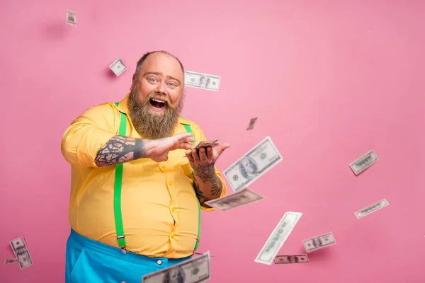 Portrait of his he nice cheerful cheery glad bearded guy throwing interest deposit investment winning cashback having fun currency flying isolated over pink pastel color background — Stock Photo, Image