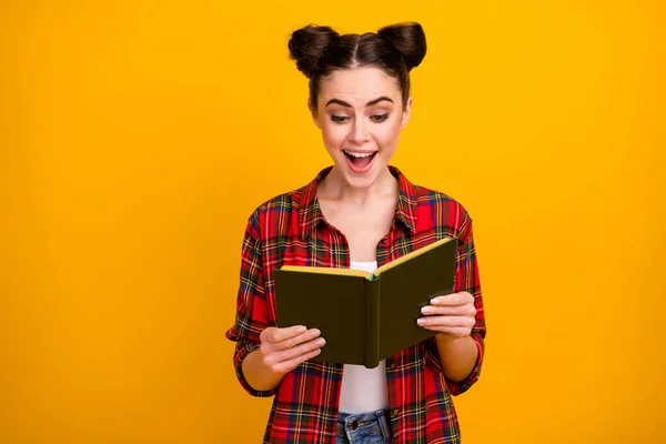 Photo of pretty student lady two cute buns open mouth hold book read interesting adventure story favorite novel wear casual white red plaid shirt isolated yellow color background — Stock Photo, Image