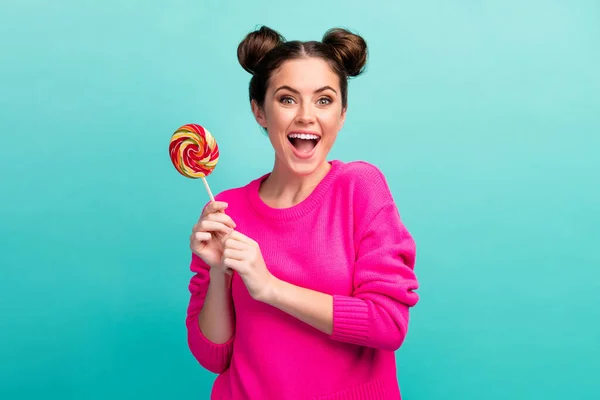 Portrait of her she nice attractive lovely charming pretty cheerful cheery teenage girl holding in hand lolli pop having fun isolated over bright vivid shine vibrant blue turquoise color background — Stock Photo, Image