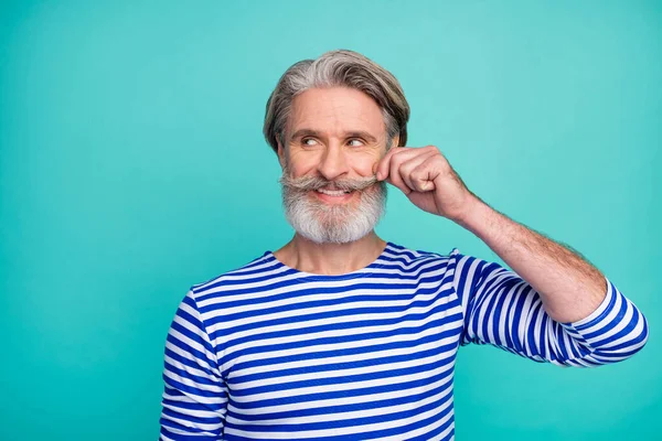 Close-up portrait of his he nice attractive cheerful grey-haired virile macho man wearing striped jumper touching mustache isolated on bright vivid shine vibrant green blue turquoise color background — Stock Photo, Image