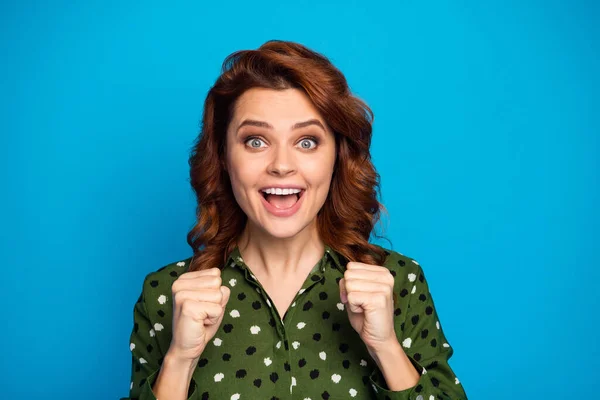 Jo. Closeup photo of pretty curly foxy shocked lady open mouth listen good news raise fists successful person wear green dotted office shirt isolated bright blue color background — Stock fotografie