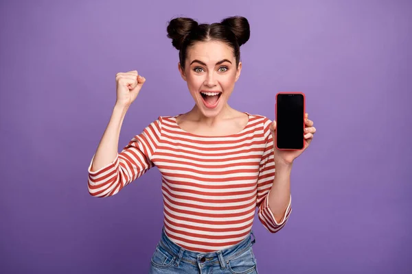 Фото смішної божевільної леді тримає нову модель смартфона сенсорний екран підняти кулак виграти безкоштовну лотерею продажу смартфонів одяг біло-червона повсякденна смугаста сорочка ізольована фіолетовий пастельний кольоровий фон — стокове фото