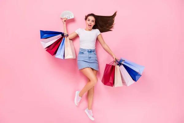 Top above high angle view full length photo of shocked girl center client impressed hold money fan bags win lottery lay wear short mini denim jeans skirt isolated over pastel color background — Stock Photo, Image