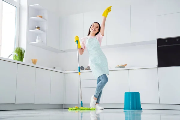 Full length photo of asian ethnicity housewife general cleaning disinfecting all surfaces infection safety hold mop clean floor wear gloves apron t-shirt jeans stand kitchen indoors — Stock Photo, Image