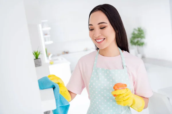 Photo of asian ethnicity housewife general cleaning disinfecting all surfaces home corona virus safety hold spray wear gloves apron t-shirt stand kitchen indoors — Stock Photo, Image
