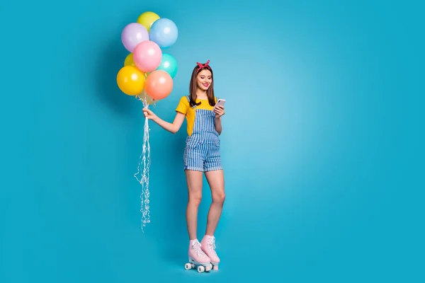 Full length body size view of her she nice attractive lovely cheerful girl standing on roll skates using 5g holding in hands air balls isolated over bright vivid shine vibrant blue color background — Stock Photo, Image