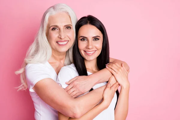 Close-up portrait of two nice attractive lovely charming pretty cute sweet careful adorable gentle cheerful cheery women embracing cuddling spending day isolated over pink pastel color background — Stock Photo, Image