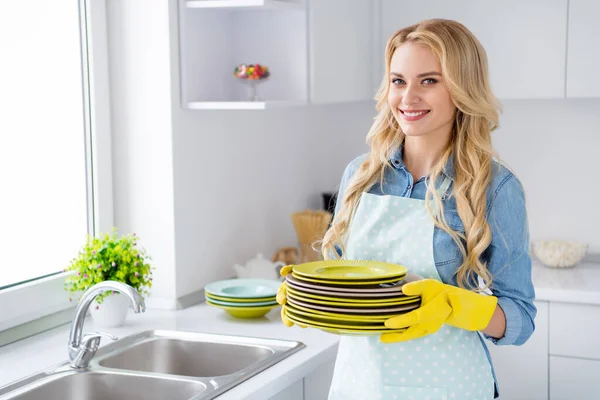 Photo of cheerful housewife blond lady hold clean plates stack good mood finish fast service spring cleaning worker house maid for hour stand modern kitchen indoors — Stock Photo, Image