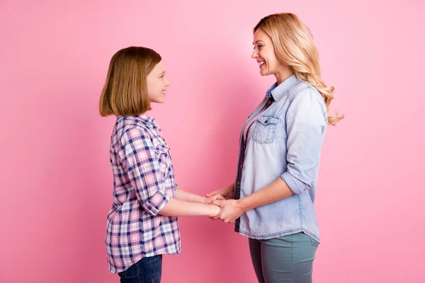 Foto del lado del perfil de la encantadora remolque agradable gente madre hija toma de la mano disfrutar de pasar tiempo libre fin de semana juntos usar vaqueros a cuadros camisa a cuadros aislado pastel color fondo — Foto de Stock