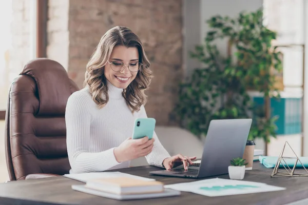 Portrait of her she nice attractive cheerful focused wavy-haired girl marketing director using digital device sending sms in modern loft brick industrial interior style workplace workstation — Stock Photo, Image
