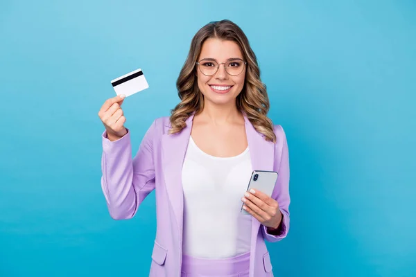 Positive successful business lady boss executive manager use smartphone pay salary income profit credit card show recommend bank wear suit violet blazer jacket isolated blue color background