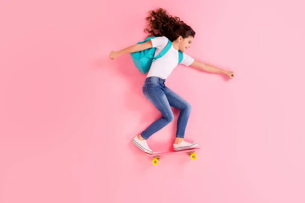 Visão superior acima de alto ângulo flat lay flatlay lie concept full length body size view of nice cheerful cheery girl jumping standing on board riding having fun isolated on pink pastel color background — Fotografia de Stock