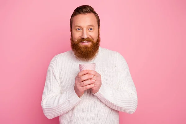 Portrait of content funky ginger hair man hold cup with hot cappuccino wear warm sweater isolated over pastel color background — Stock Photo, Image