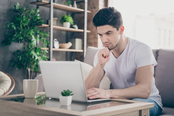 Portrait of his he nice attractive focused serious guy it geek specialist sitting on divan preparing report presentation working remotely at modern industrial loft interior style living-room indoors — Stock Photo, Image