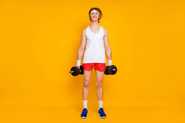 Full length body size view of his he nice attractive cheerful cheery slim thin guy sportsman doing work out holding in hand barbell isolated over bright vivid shine vibrant yellow color background — Stock Photo, Image