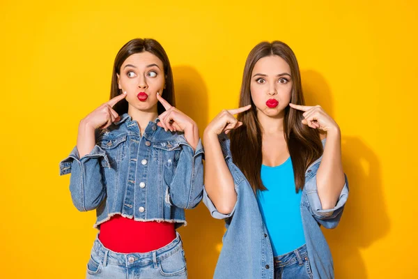 Портрет фанк-божевільних дурних дівчат індексний палець, який надуває щоки, носить джинсовий одяг, ізольований на яскравому кольоровому фоні — стокове фото