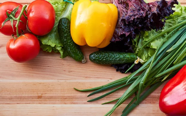 Fresh vegetables variety on the wooden table. Food layout. Copy space