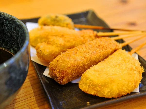 Fried tempura of fish paste on black platter