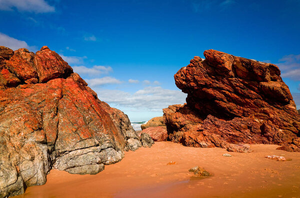 Large rock formations on sandy beach at Port Macquarie Australia