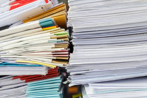 Close up of business papers stack on desk. Pile of unfinished documents on office desk