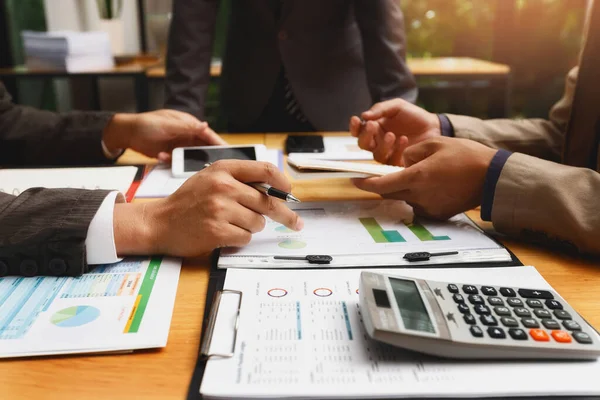 Business team meeting and discussing project plan. Businessmen discussing together in meeting room. Professional investor working with business project together. Finance managers task.