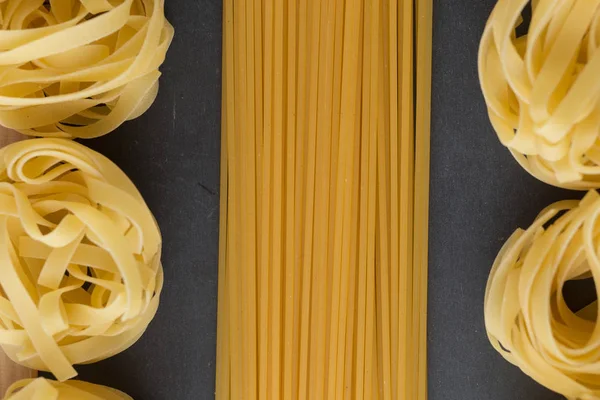 Makarna ham closeup arka plan çeşitli karışımı. Geleneksel İtalyan mutfağı yemek için lezzetli kuru pişmemiş madde. Çeşitli şekiller dokulu. Üstten Görünüm. Kopya alanı