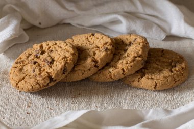 İle ışık Tekstil zemin üzerine Çikolata parçalı kurabiye kazık. Kahvaltı, Kahvaltı ve öğle yemeği için lezzetli sabah aperatifler. Apetisant, sağlıklı, tatlı, scrummy ve fast food