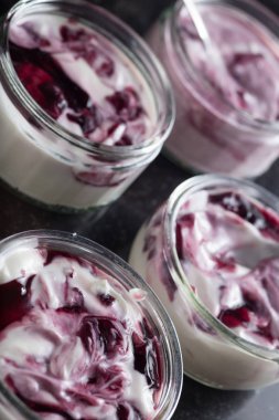 Yoğurt karanlık mermer arka plan üzerinde karışım cam kase meyve ile. Doğal ve sağlıklı meyve, diyet, gurme tatlı granola kahvaltı için. Tatlı yoğurt portre